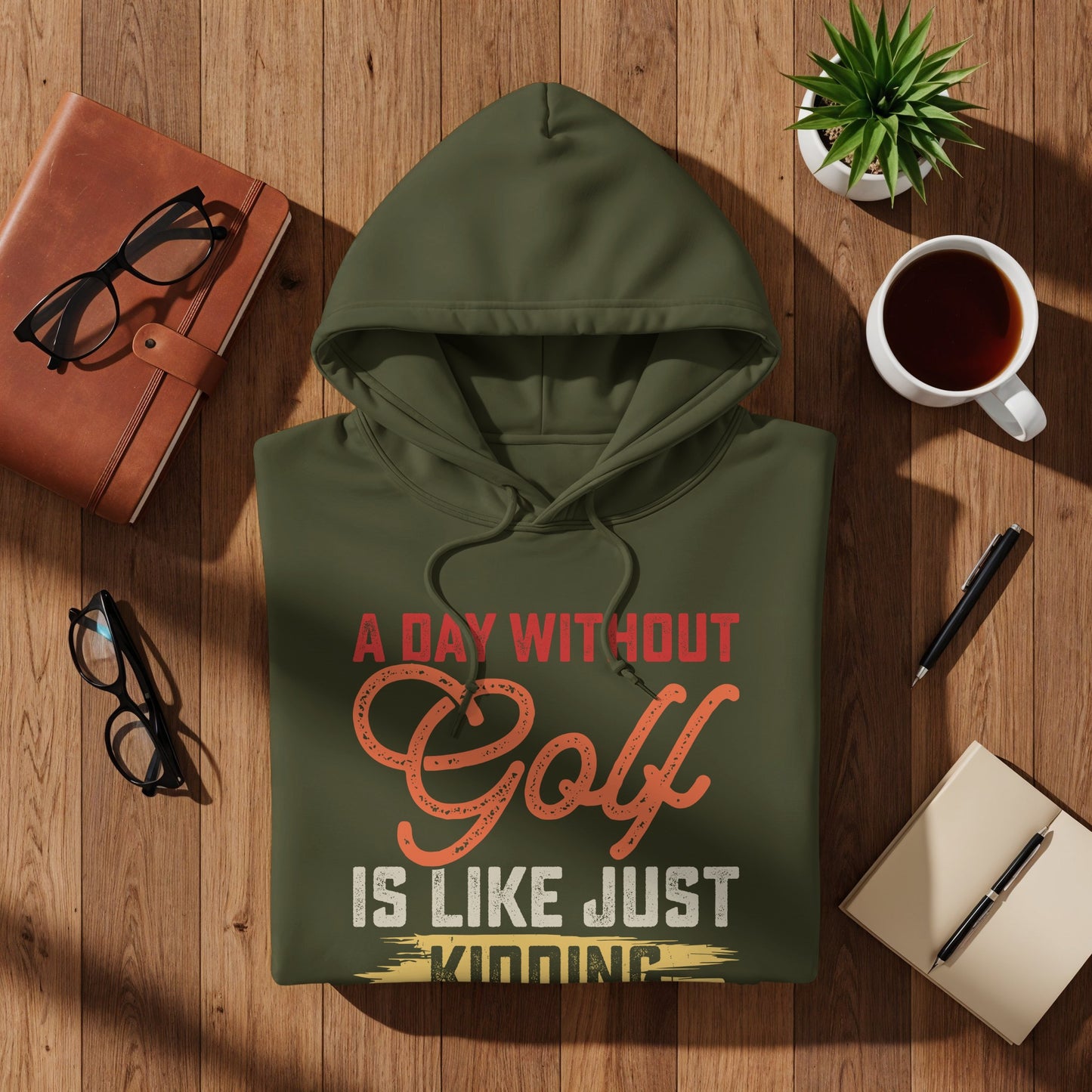 Green hoodie with "A Day Without Golf Is Like Just Kidding" text.