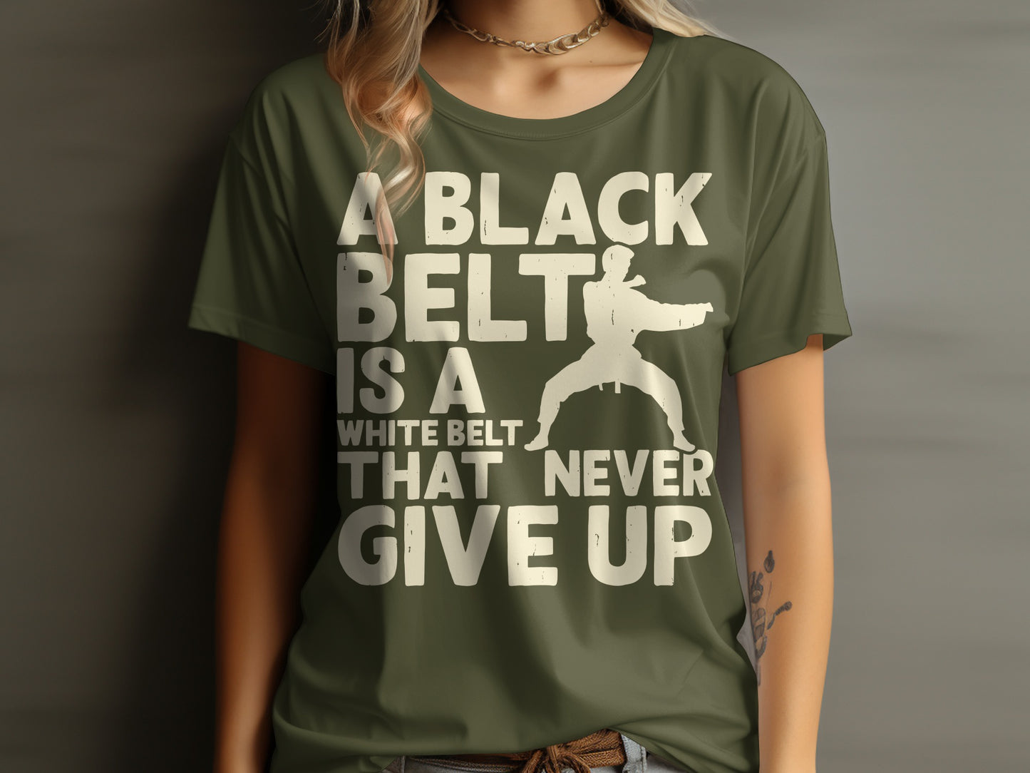 Green t-shirt with "A BLACK BELT IS A WHITE BELT THAT NEVER GIVE UP" and karate silhouette.