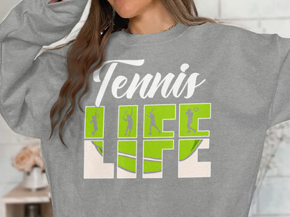 Gray sweatshirt with "Tennis Life" text and green tennis player silhouettes.