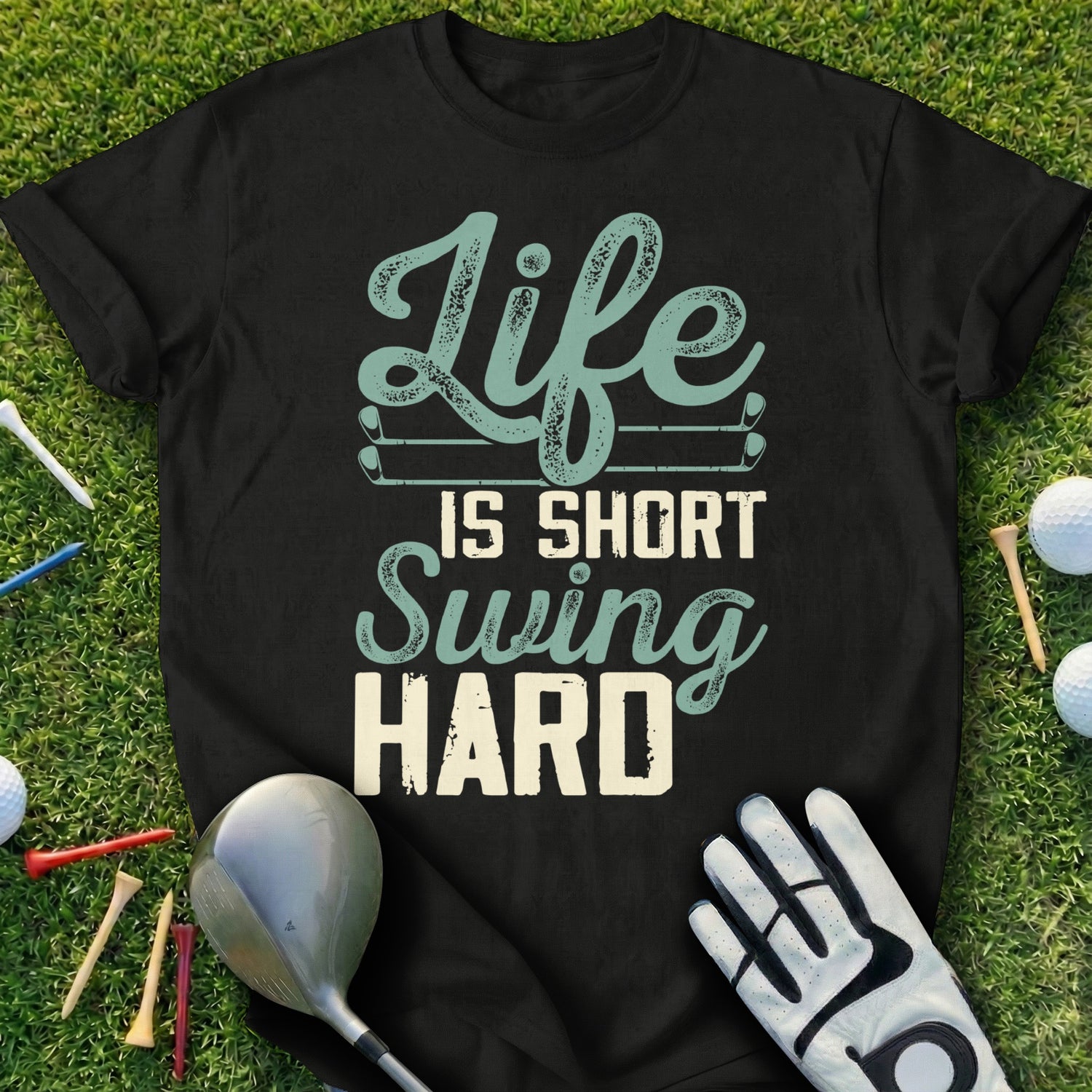 Black t-shirt with "Life is short Swing HARD" text, golf club, glove, and balls.