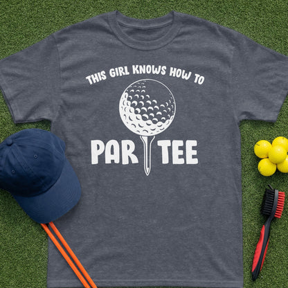 Dark grey t-shirt with "This girl knows how to par tee" graphic and golf items.