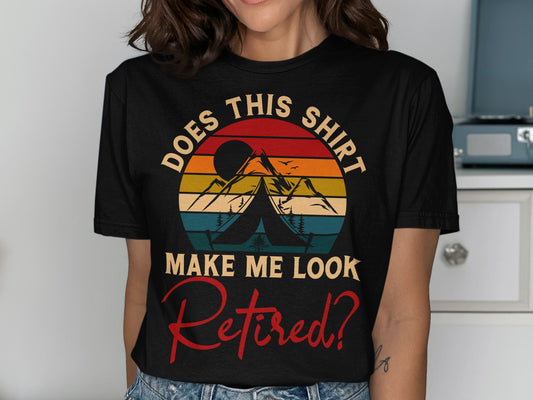 Black t-shirt with vintage sunset and camping graphic, text reads "Does This Shirt Make Me Look Retired?".