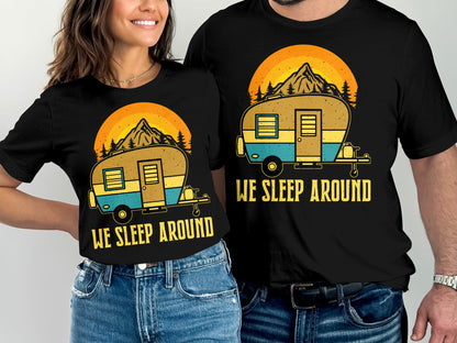 Two people wearing matching "We Sleep Around" camping t-shirts.