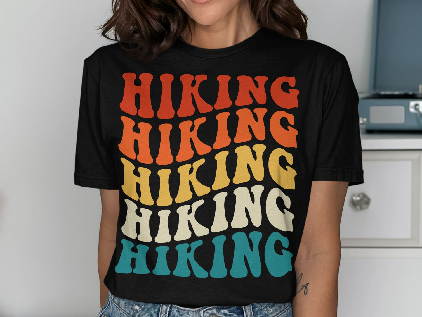 T-shirt with stacked "HIKING" text in retro colors: red, orange, yellow, and blue.