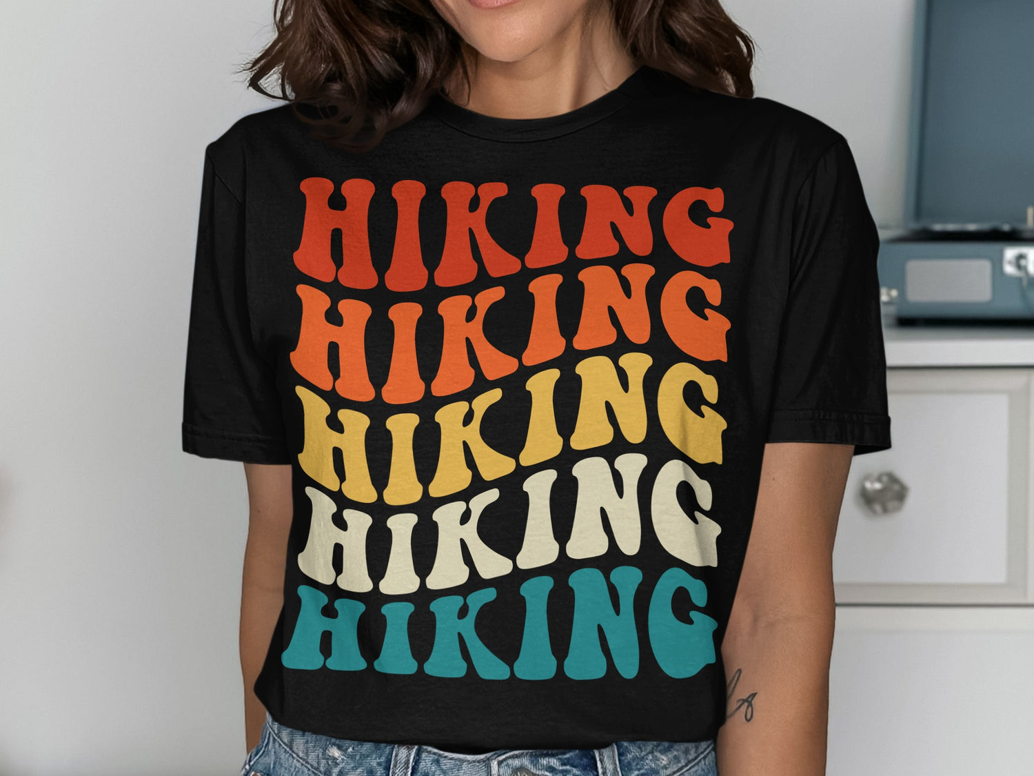 T-shirt with stacked "HIKING" text in retro colors: red, orange, yellow, and blue.