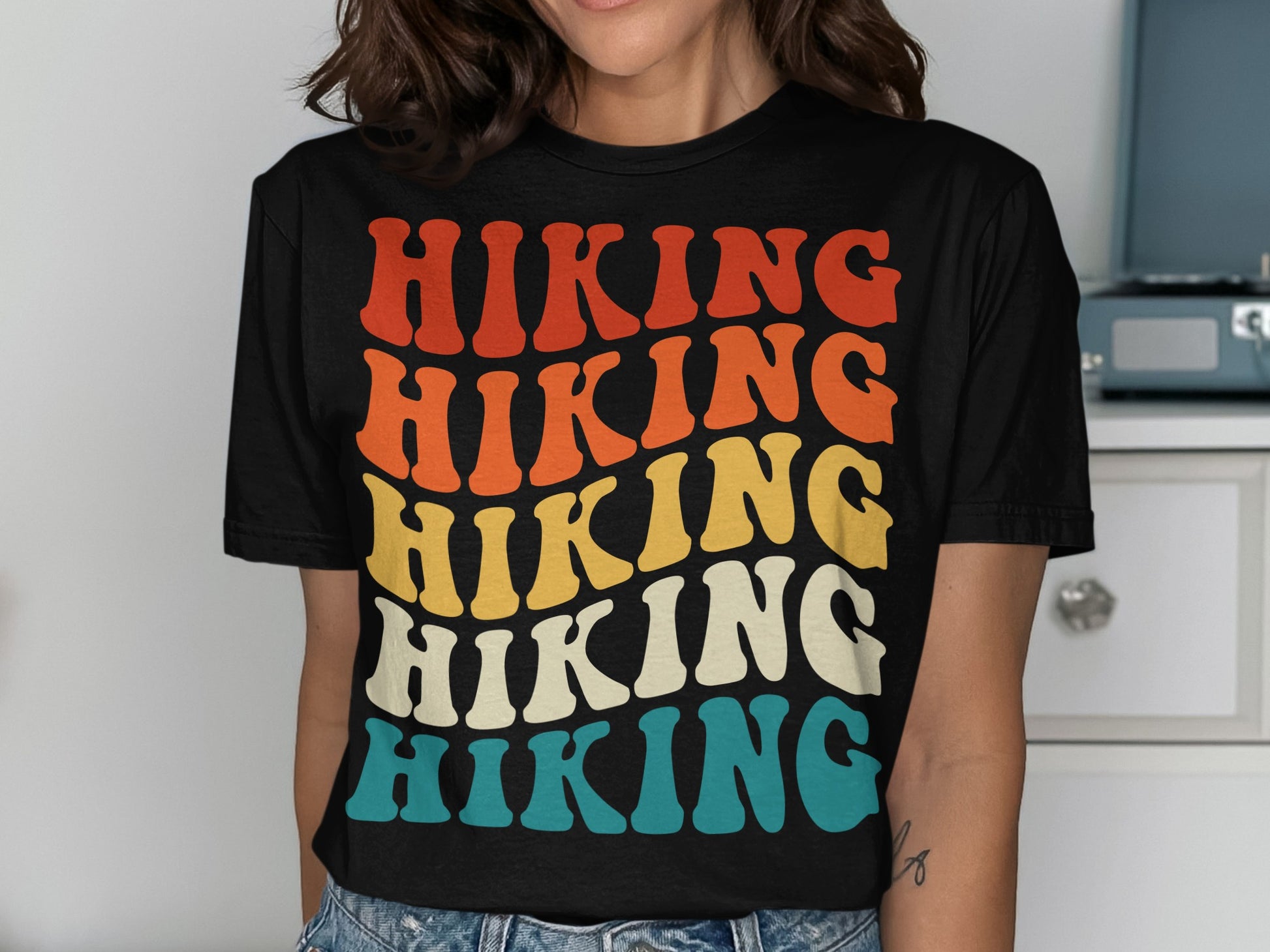 T-shirt with stacked "HIKING" text in retro colors: red, orange, yellow, and blue.