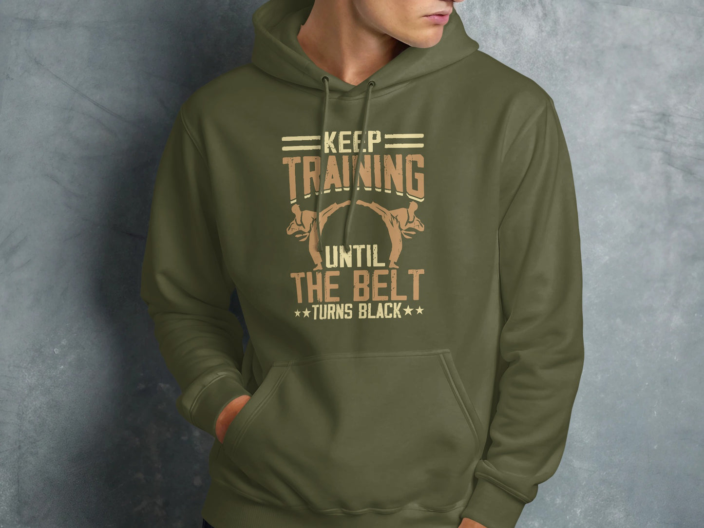 Olive green hoodie with "KEEP TRAINING UNTIL THE BELT TURNS BLACK" text and martial arts graphic.