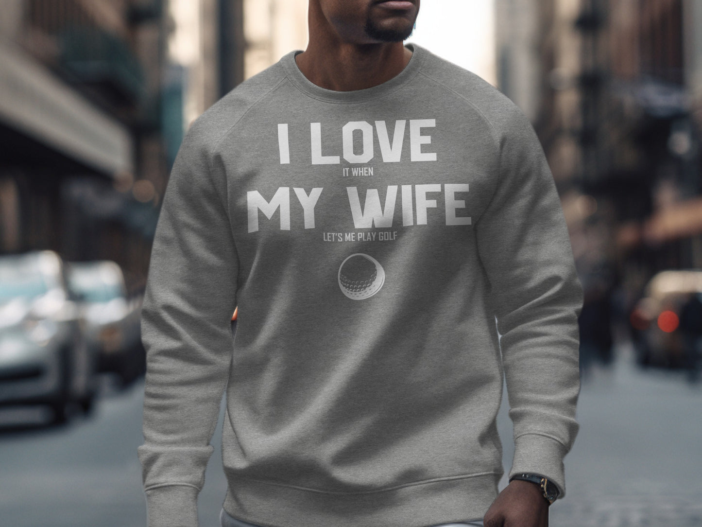 Gray sweatshirt with "I Love It When My Wife Lets Me Play Golf" text and golf ball.