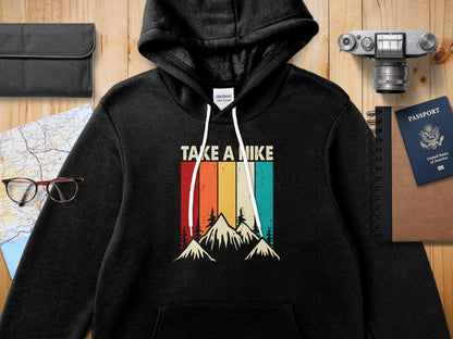 Black hooded sweatshirt with vintage mountain graphic and "TAKE A HIKE" text.