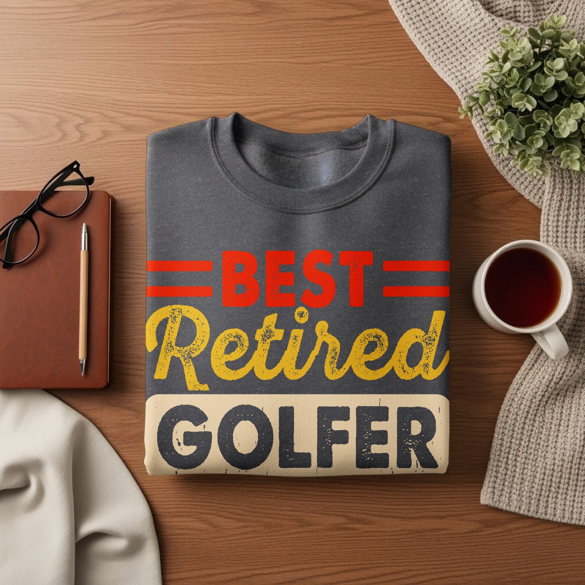 Dark gray sweatshirt with "BEST Retired Golfer" text in red and yellow.
