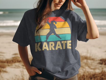 Woman wearing a dark t-shirt with a vintage karate silhouette and sunset design.