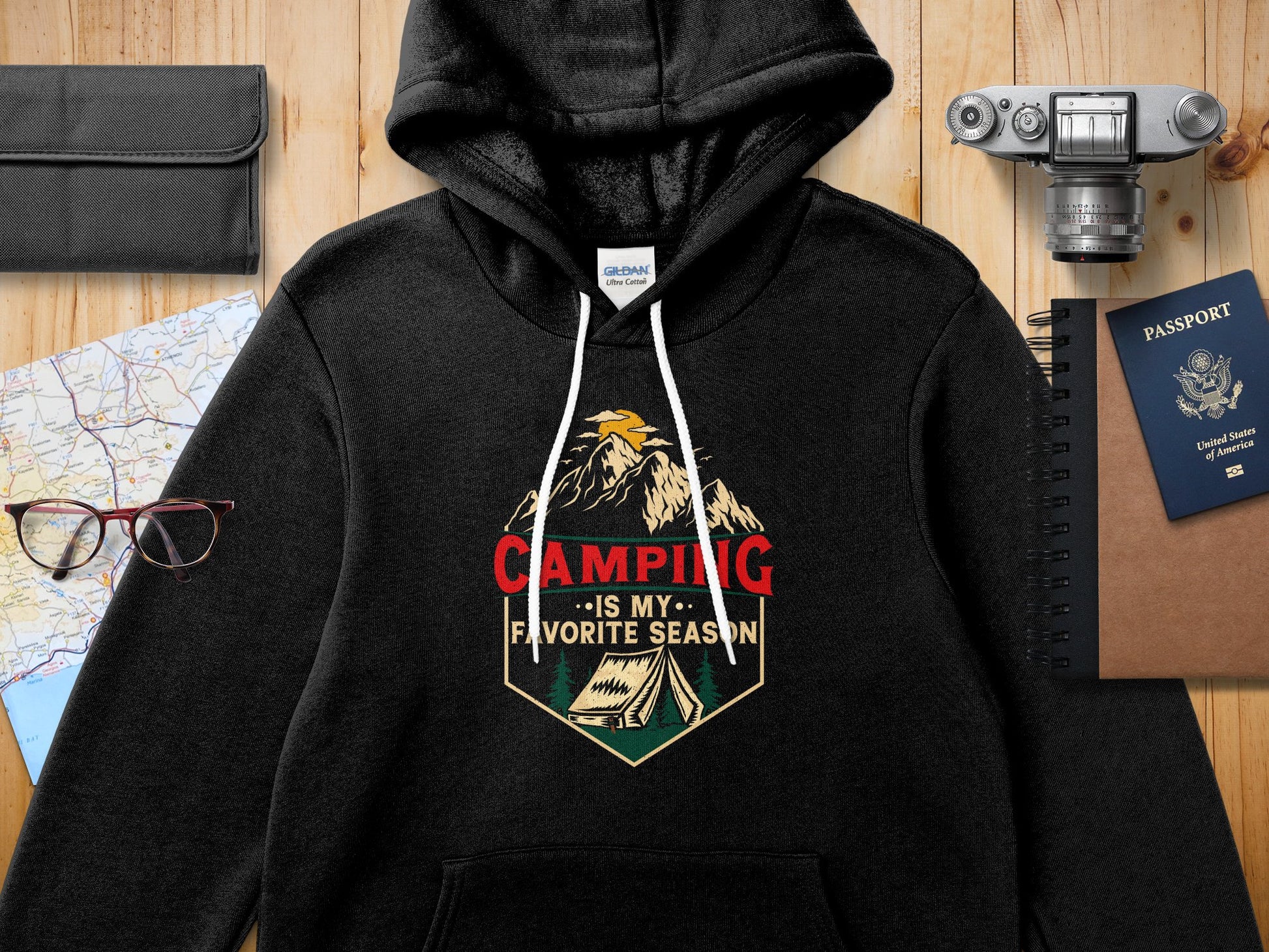 Black hoodie with "Camping is my favorite season" text and mountain graphic.