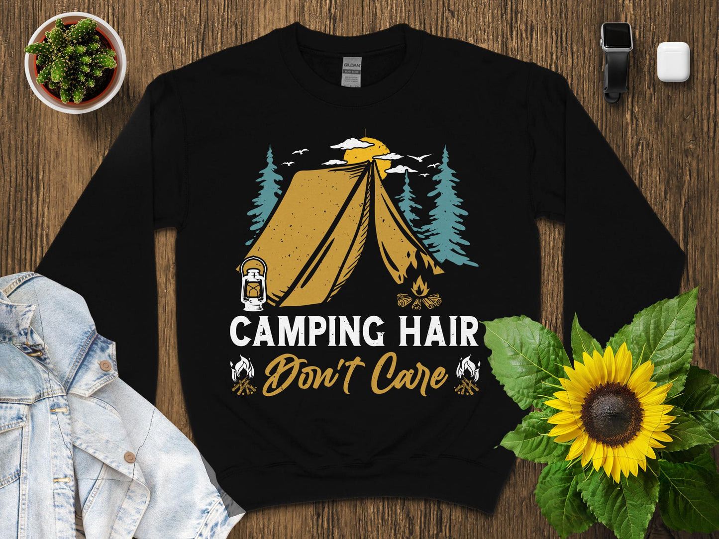 Black sweatshirt with "Camping Hair Don't Care" text and tent illustration.