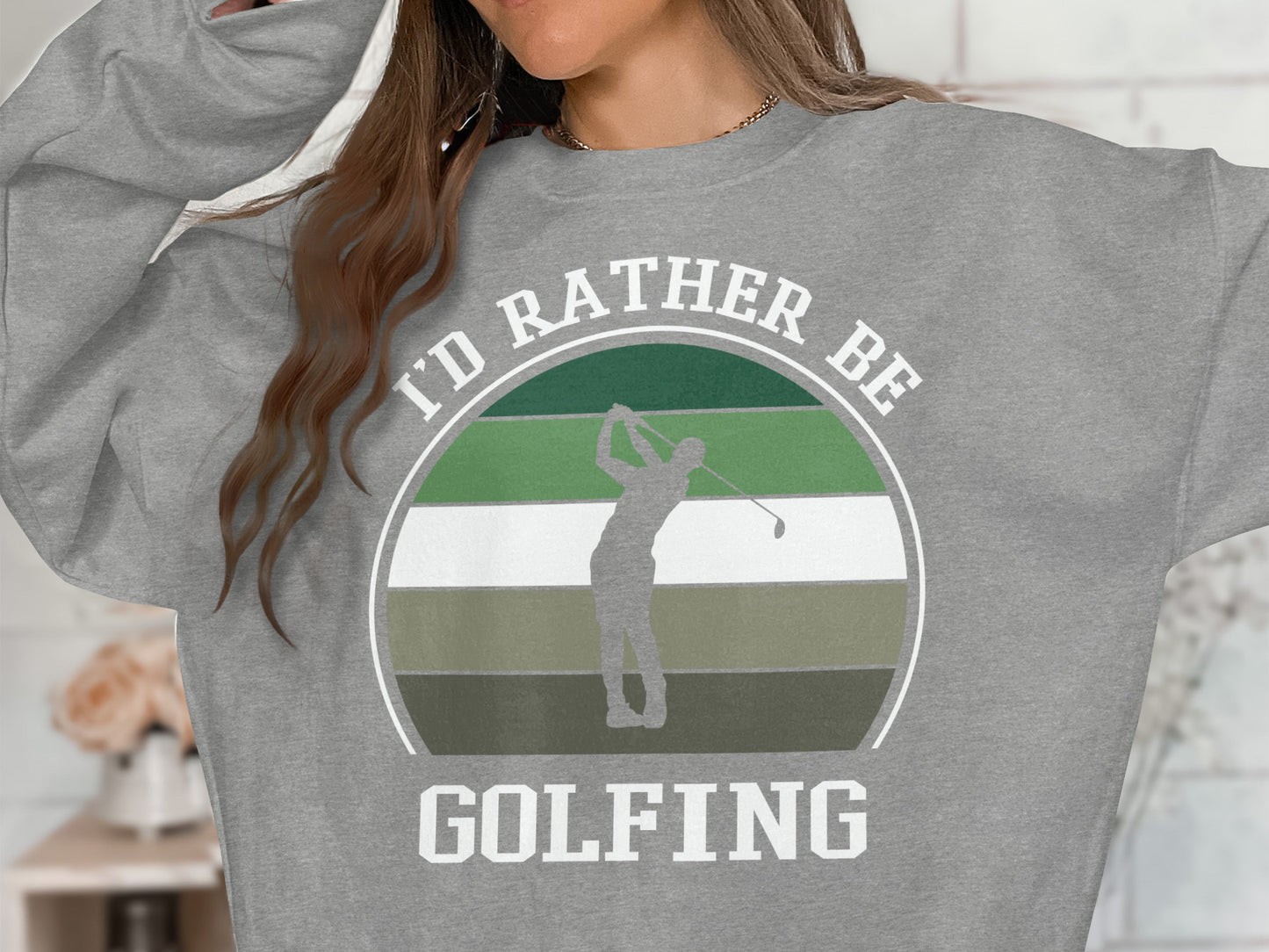 Grey sweatshirt with a graphic of a golfer and "I'd rather be golfing."