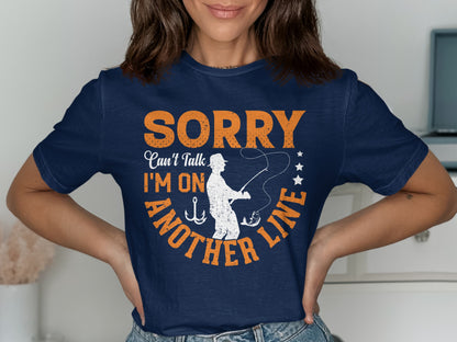 Navy t-shirt with orange text "Sorry, can't talk, I'm on another line".