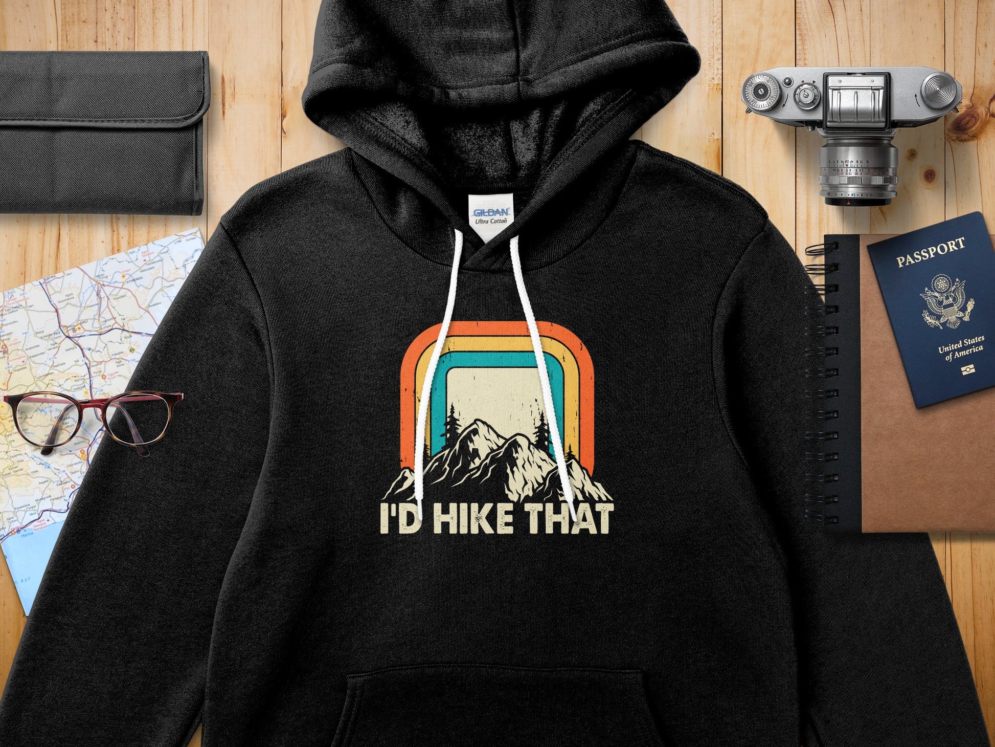 Black hoodie with retro mountain graphic and "I'd Hike That" text.