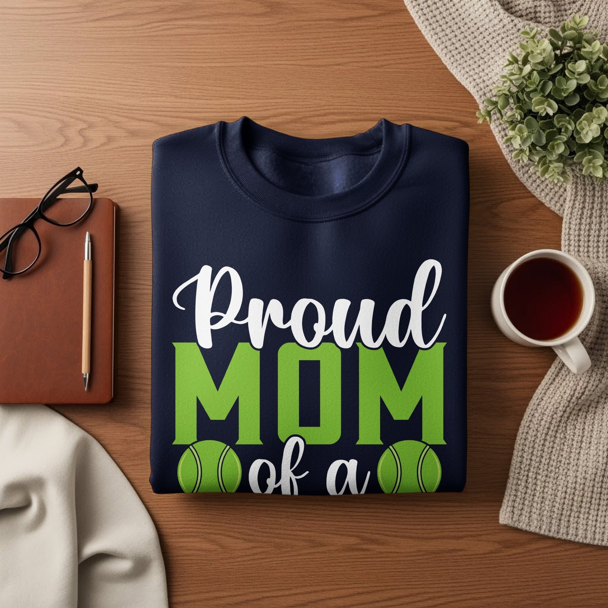 Navy sweatshirt with "Proud Mom of a" text and green tennis balls.
