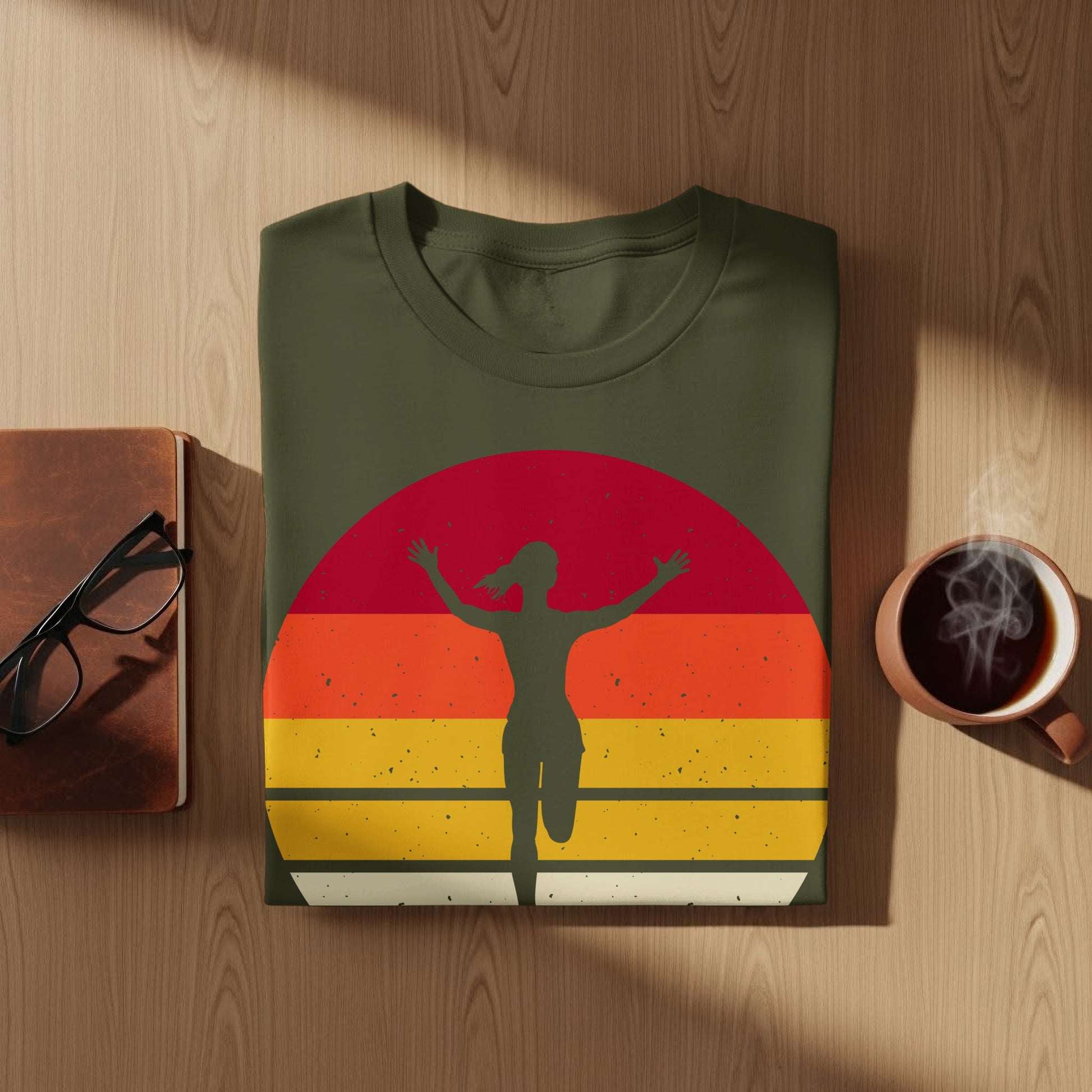 Olive green t-shirt with a sunset graphic and a running figure.
