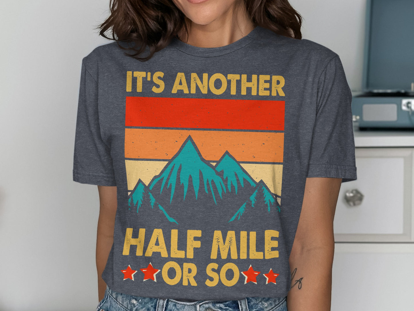 Dark grey t-shirt with retro mountain graphic and text "It's Another Half Mile or So".