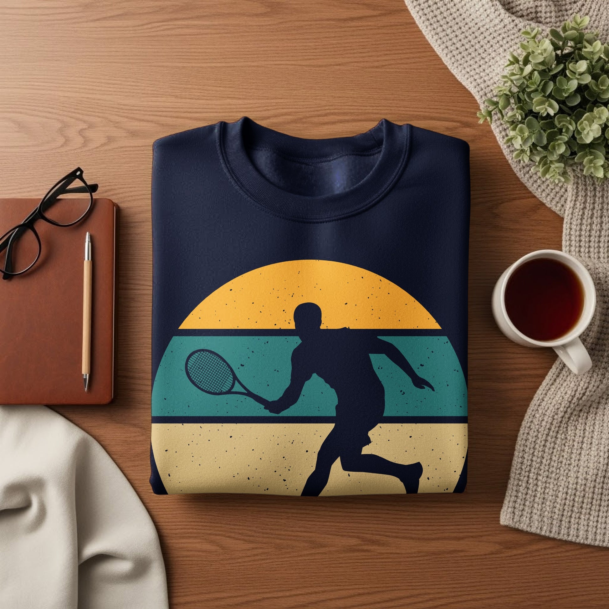 Navy sweatshirt with vintage tennis player graphic and sunset.