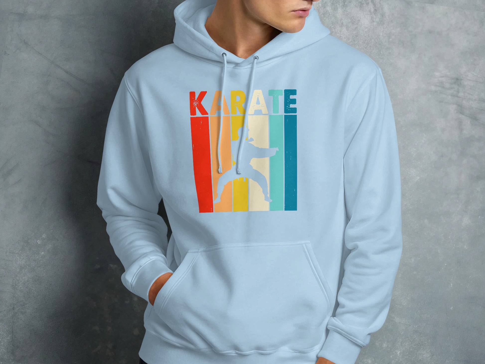 Light blue hoodie with "KARATE" in colorful retro stripes and a silhouette.