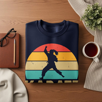 Dark blue sweatshirt with a silhouette of a karate fighter against a retro sunset.