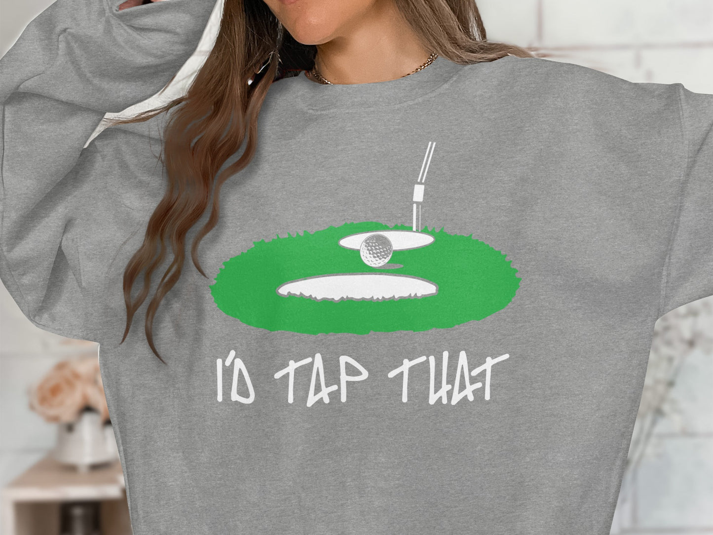 Grey sweatshirt with a golf ball on a tee over a green golf hole graphic and text "I'D TAP THAT".