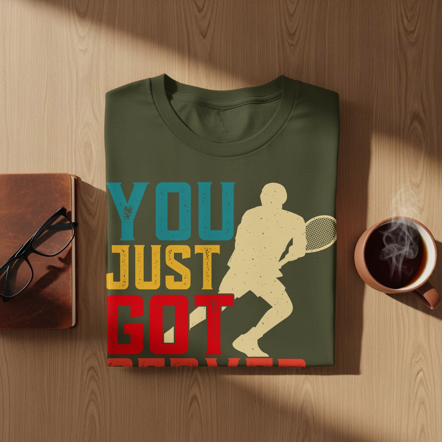 Olive t-shirt with graphic "YOU JUST GOT SERVED" and tennis player silhouette.