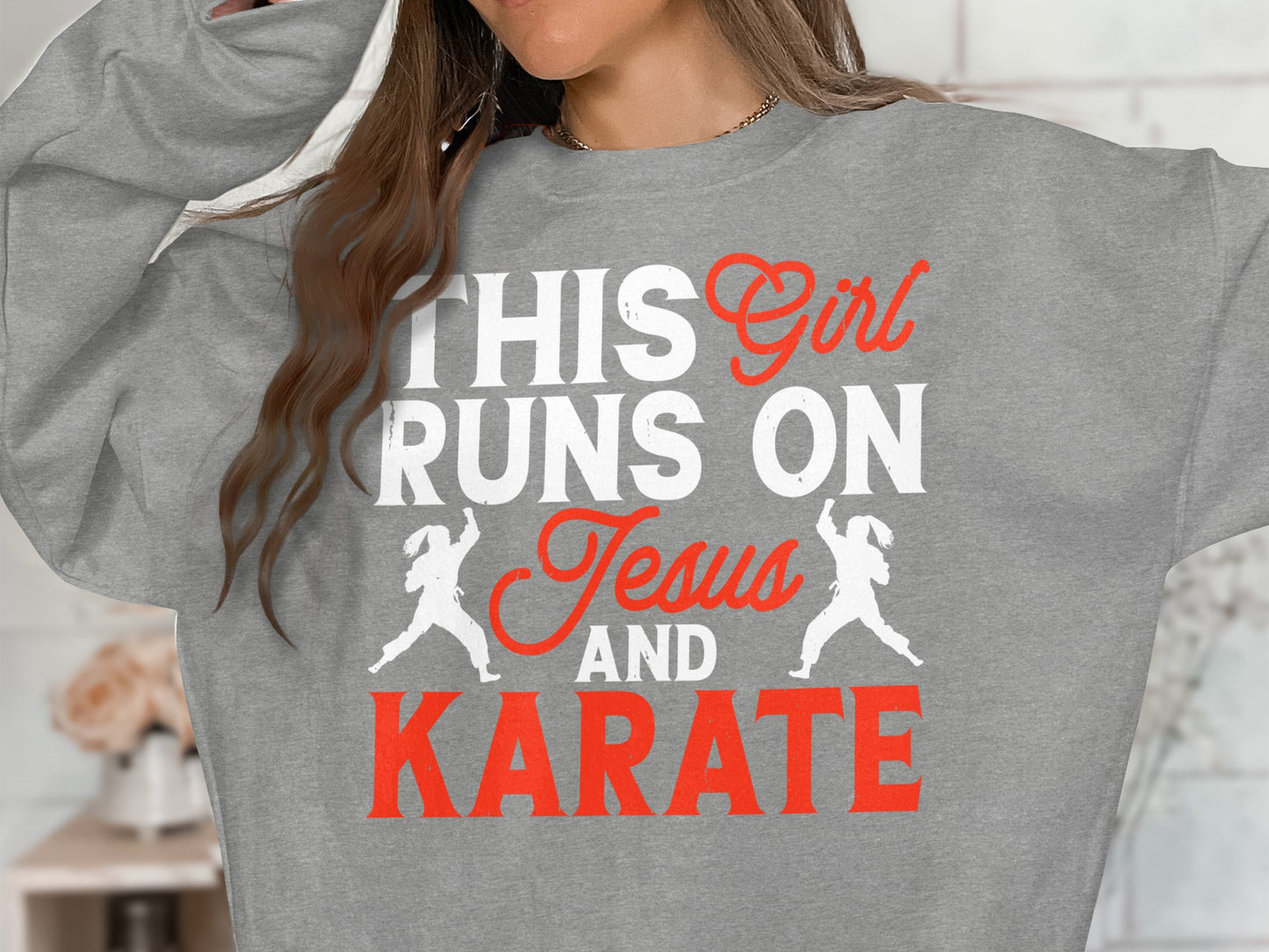 Grey sweatshirt with "This girl runs on Jesus and Karate" text and karate silhouettes.