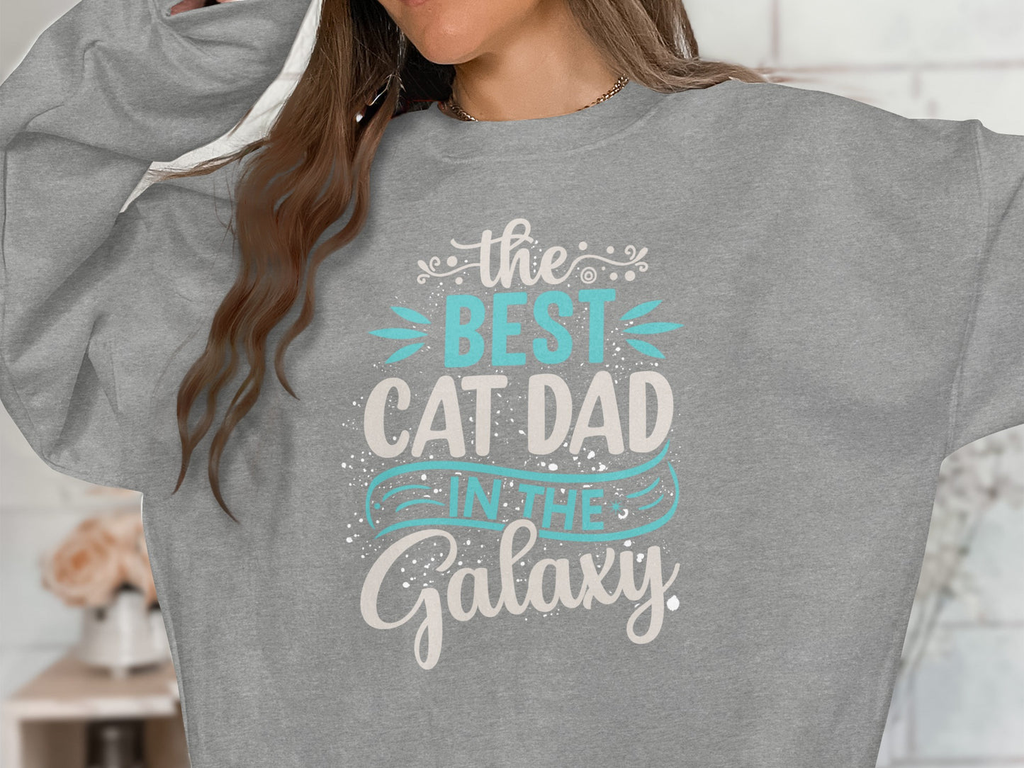 Grey sweatshirt with "The best cat dad in the Galaxy" text design.