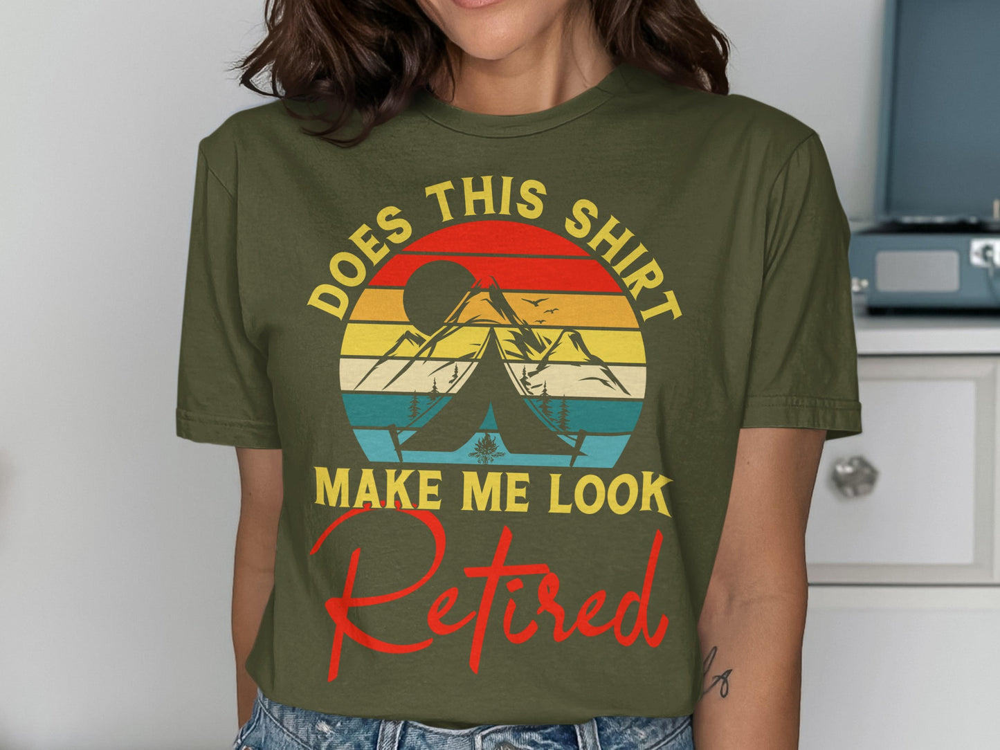 Green t-shirt with "Does this shirt make me look Retired" and a mountain scene.