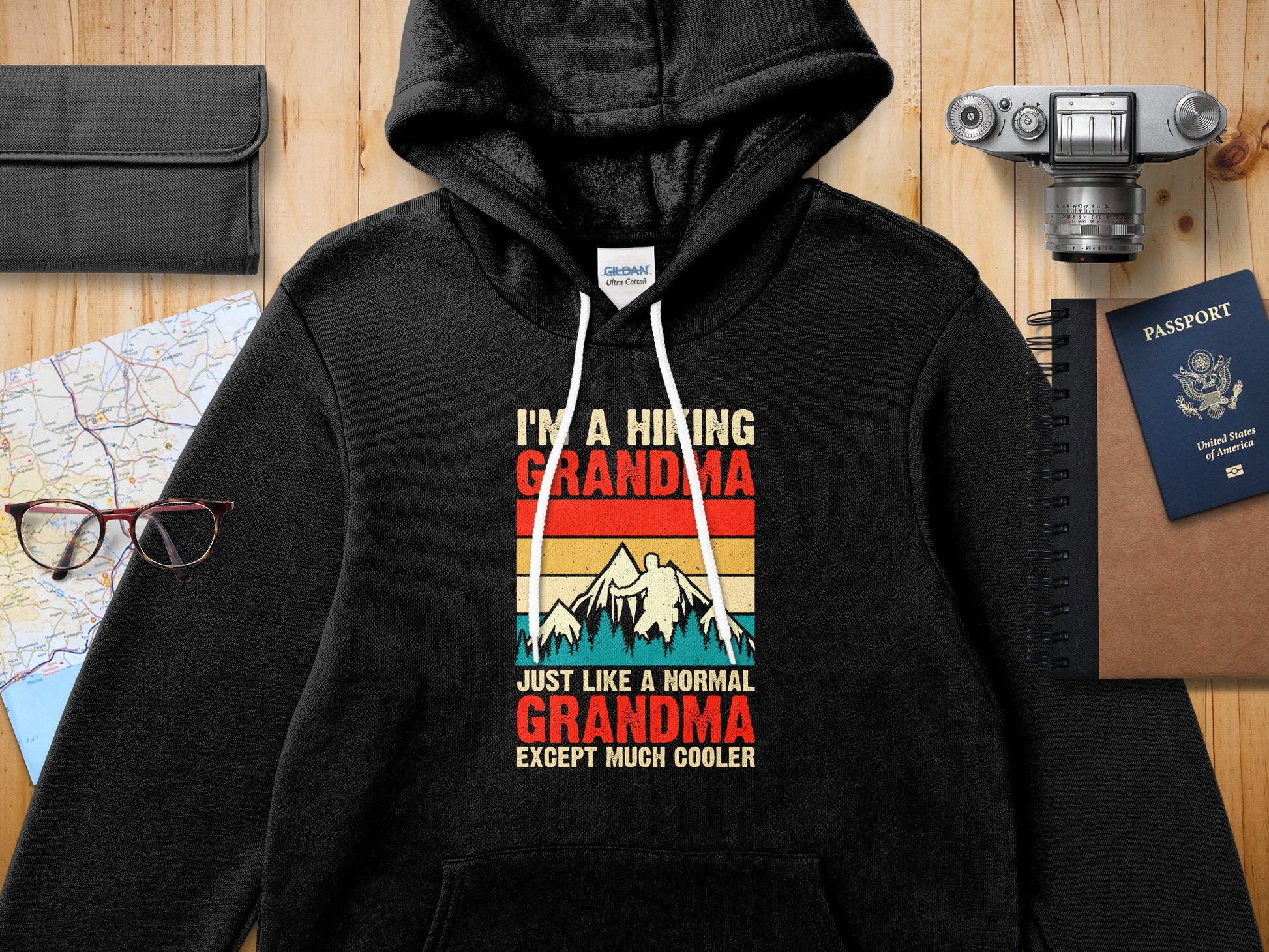 Black hoodie with text "I'M A HIKING GRANDMA JUST LIKE A NORMAL GRANDMA EXCEPT MUCH COOLER".