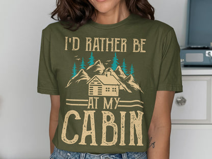 Green t-shirt with "I'd rather be at my cabin" text and mountain graphic.